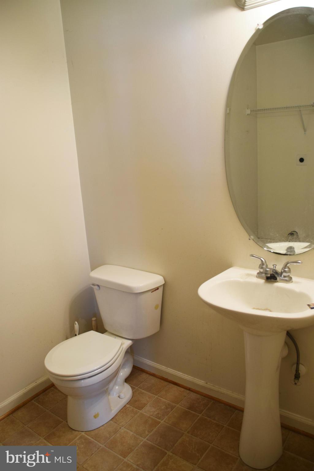 25 Fuzzy Tail Drive Ranson, WV 25438 - Photo 10 of 25 a white toilet sitting next to a bathroom sink