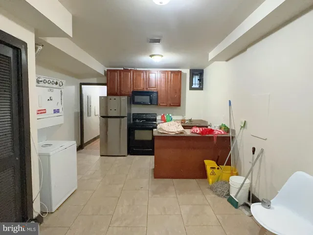 a kitchen with stainless steel appliances kitchen island granite countertop a refrigerator and a stove