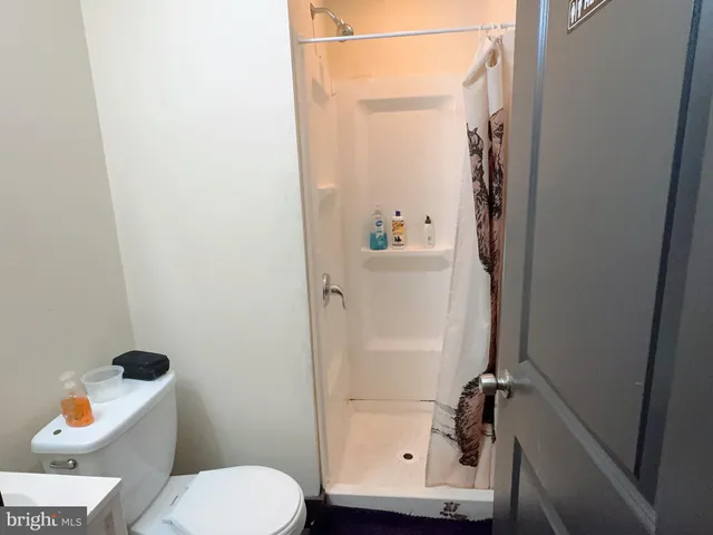 a bathroom with a toilet and a shower