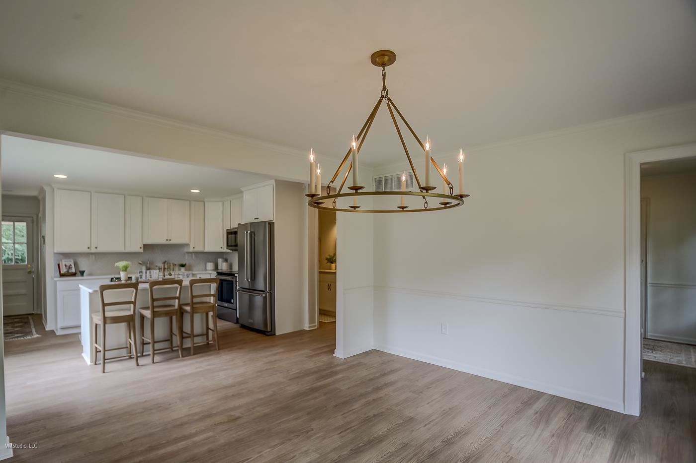 7578 Apple Valley Road Germantown, TN 38138 - Photo 7 of 22 Interior space featuring white cabinetry, a center island, light wood-type flooring, and stainless steel appliances
