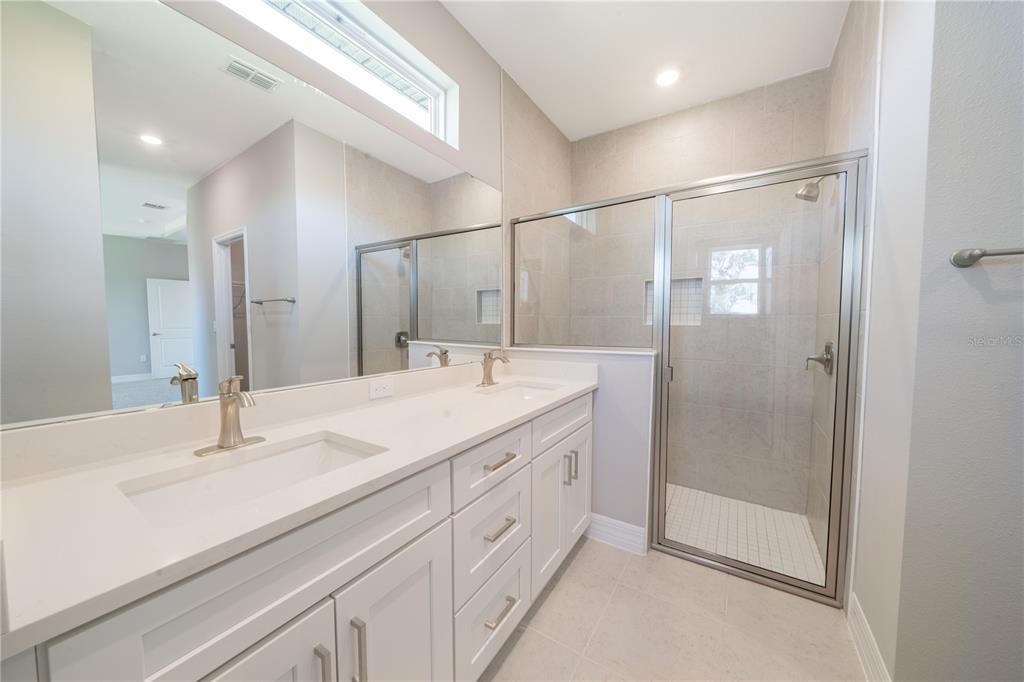 6137 Monegro Street Sebring, FL 33872 - Photo 16 of 30 a bathroom with a double vanity sink and mirror