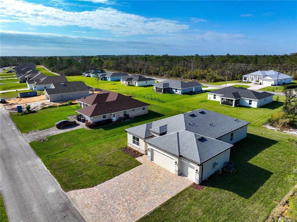 6137 Monegro Street Sebring, FL 33872 - Photo 27 of 30 an aerial view of a house with a garden and lake view