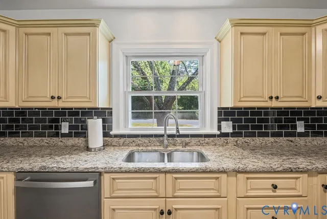 a kitchen with granite countertop a stove and a refrigerator