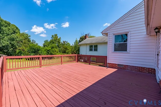 a view of backyard with deck and garden