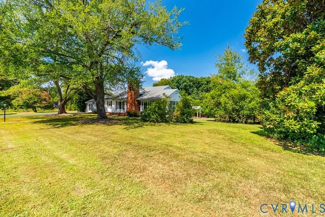 a view of a house with pool and garden