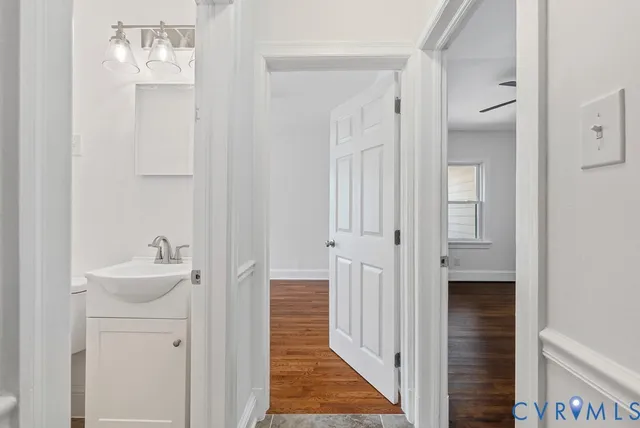 a white toilet sitting next to a white sink