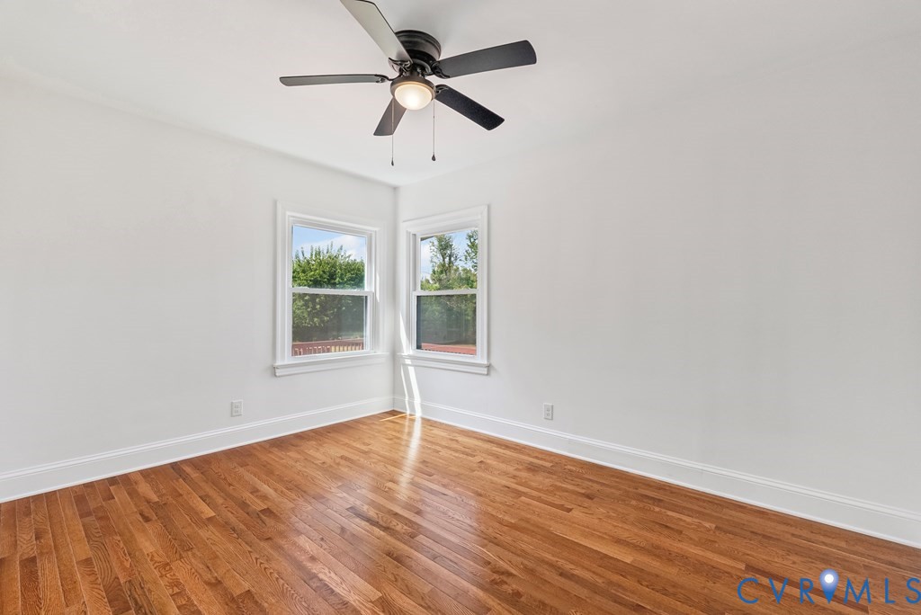 579 Stokes Road Farmville, VA 23901 - Photo 46 of 49 an empty room with wooden floor fan and windows