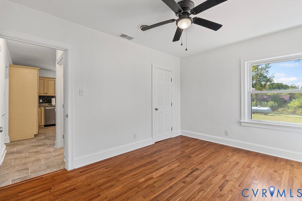 579 Stokes Road Farmville, VA 23901 - Photo 47 of 49 a view of empty room with wooden floor and fan
