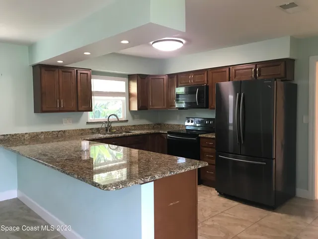 a kitchen with a refrigerator sink and microwave