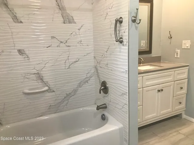 a bathroom with a bathtub and shower
