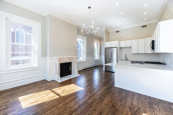 a view of a kitchen with a stove cabinets and wooden floor
