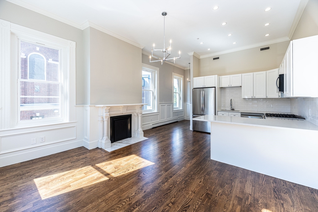 a view of a kitchen with a stove cabinets and wooden floor