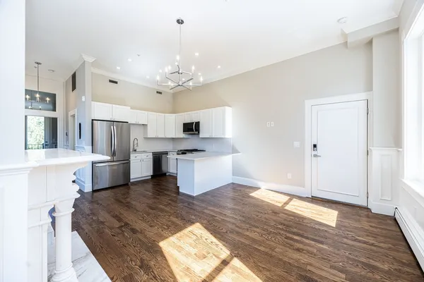 a large white kitchen with cabinets