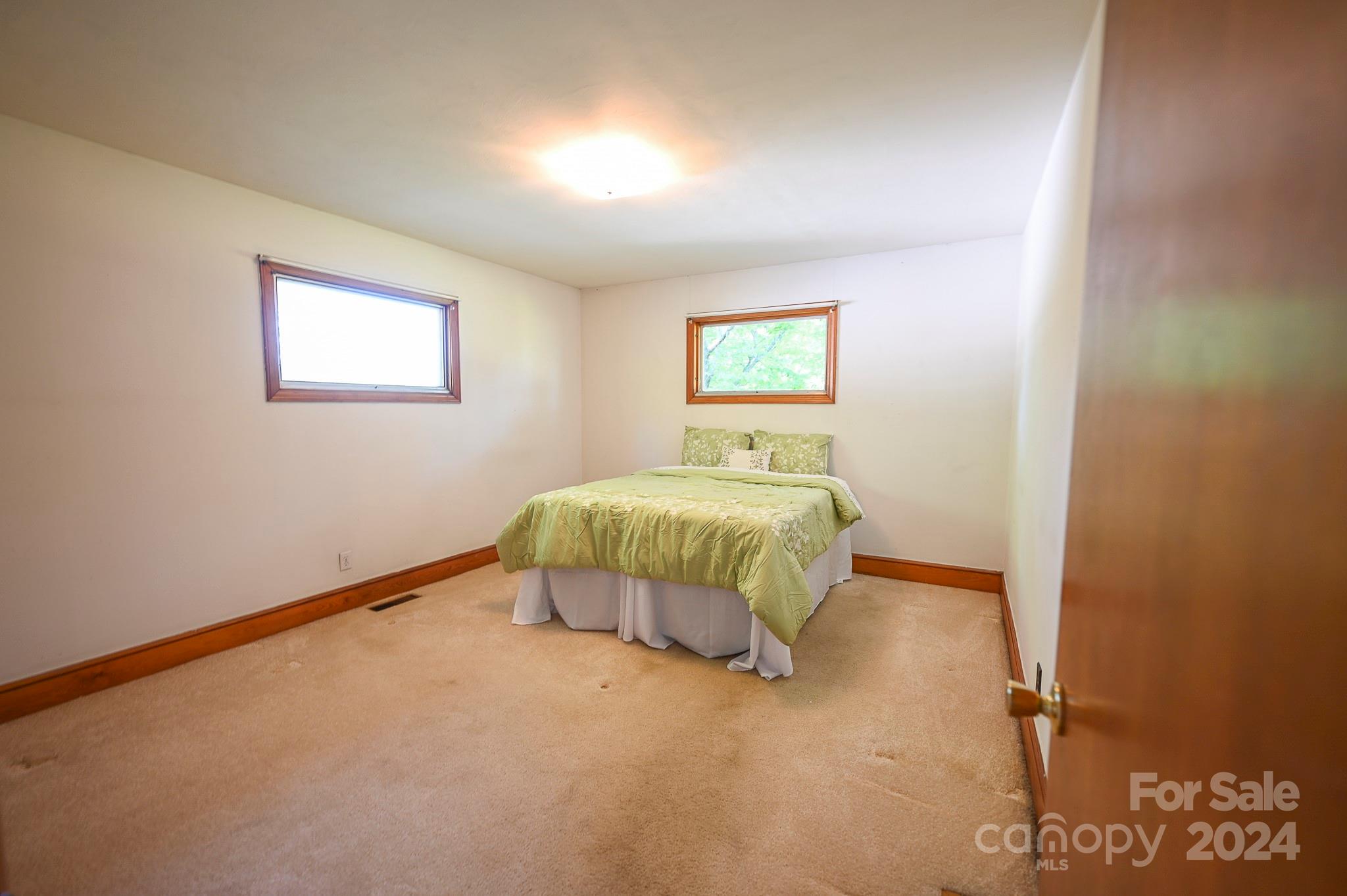 774 Poors Ford Road Rutherfordton, NC 28139 - Photo 17 of 25 a bedroom with a bed and painting on the wall