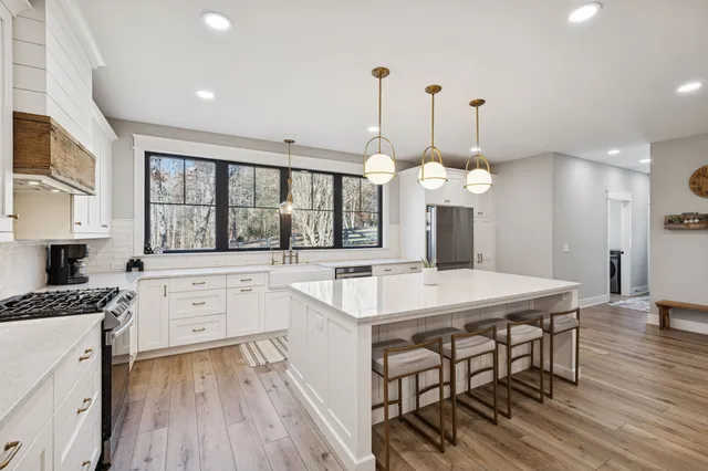 a kitchen with a table chairs stove and cabinets
