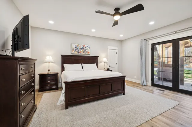 a spacious bedroom with a bed closet and flat tv screen