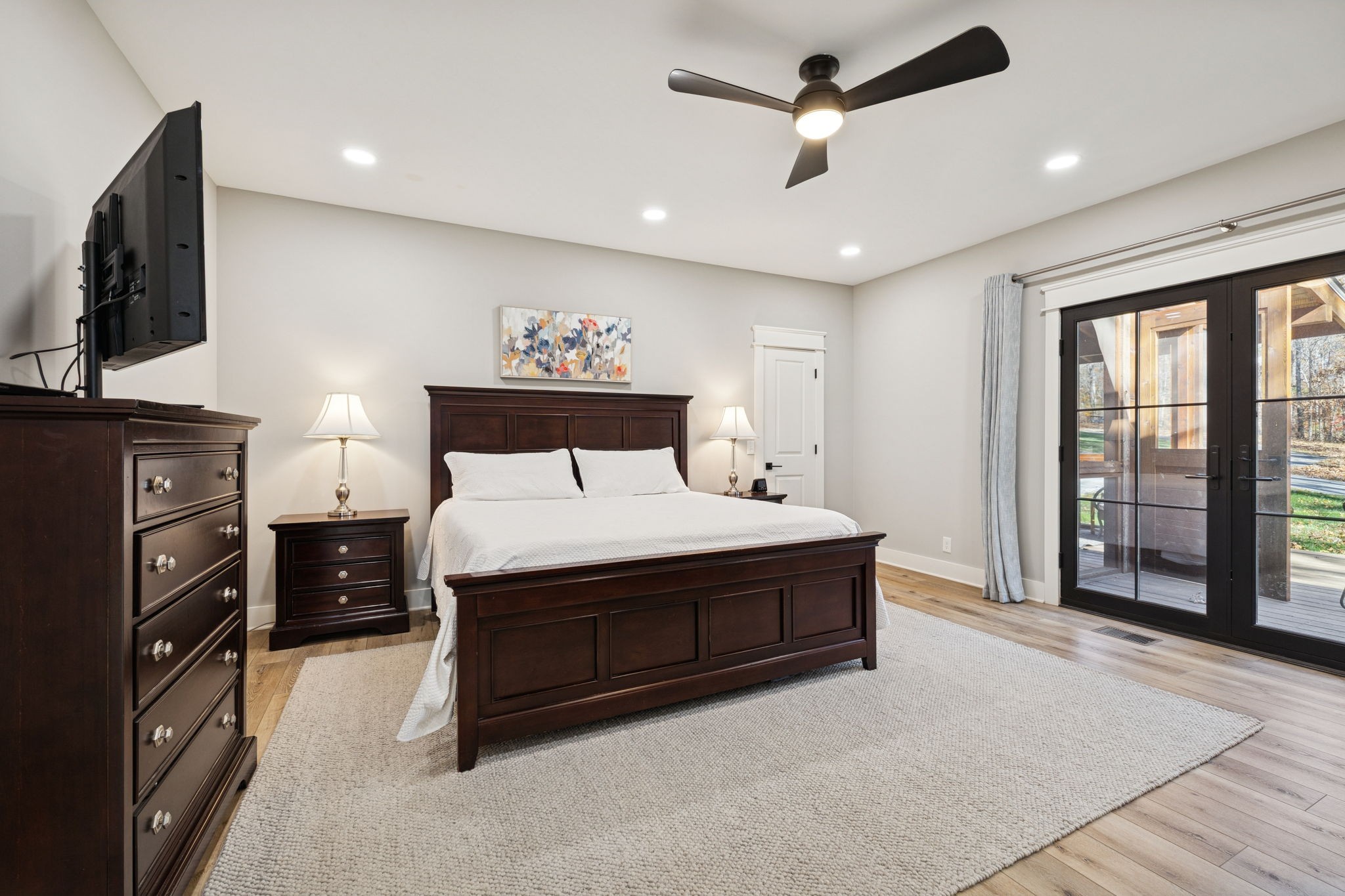 7340 Bradford Road Primm Springs, TN 38476 - Photo 16 of 36 a spacious bedroom with a bed closet and flat tv screen