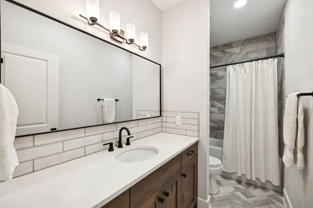 a bathroom with a double vanity sink and a mirror