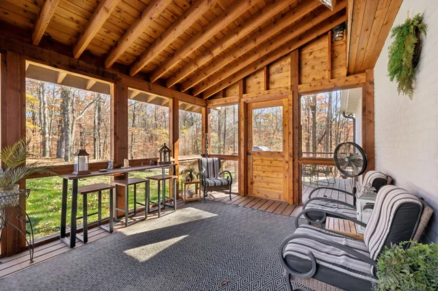 a living room with furniture and a floor to ceiling window