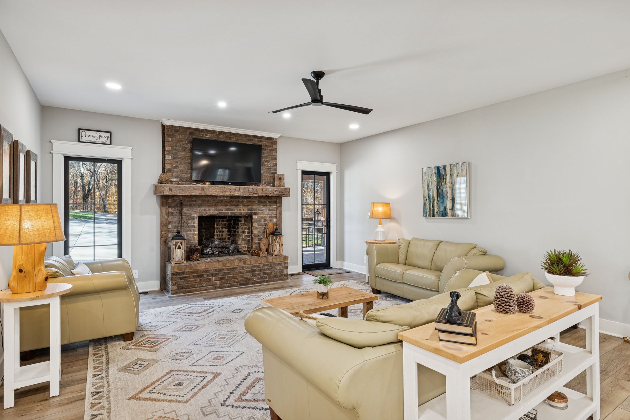 7340 Bradford Road Primm Springs, TN 38476 - Photo 8 of 36 a living room with furniture a fireplace and a flat screen tv