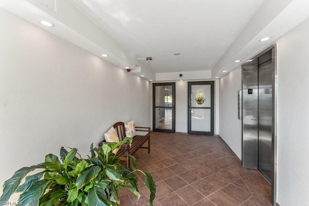 200 Pebble Beach Boulevard, Unit D402 Naples, FL 34113 - Photo 11 of 11 a view of a hallway with staircase