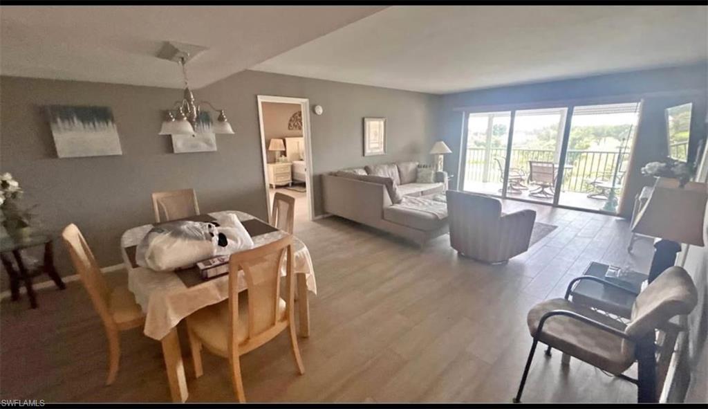 200 Pebble Beach Boulevard, Unit D402 Naples, FL 34113 - Photo 4 of 11 a living room with furniture and a large window
