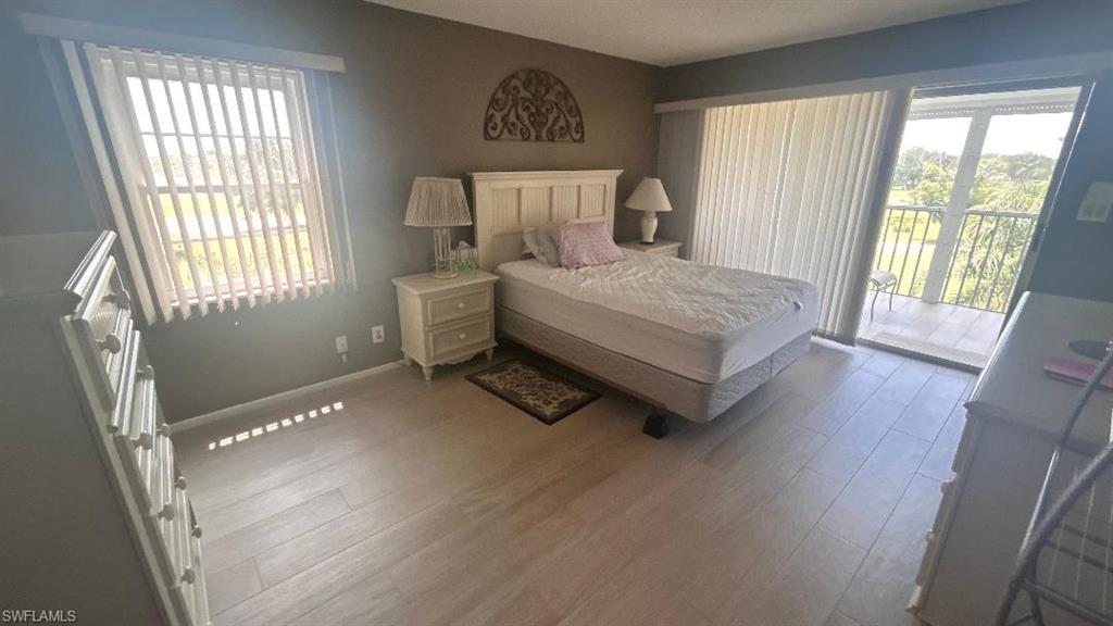 200 Pebble Beach Boulevard, Unit D402 Naples, FL 34113 - Photo 7 of 11 a bed sitting in a bedroom next to a window