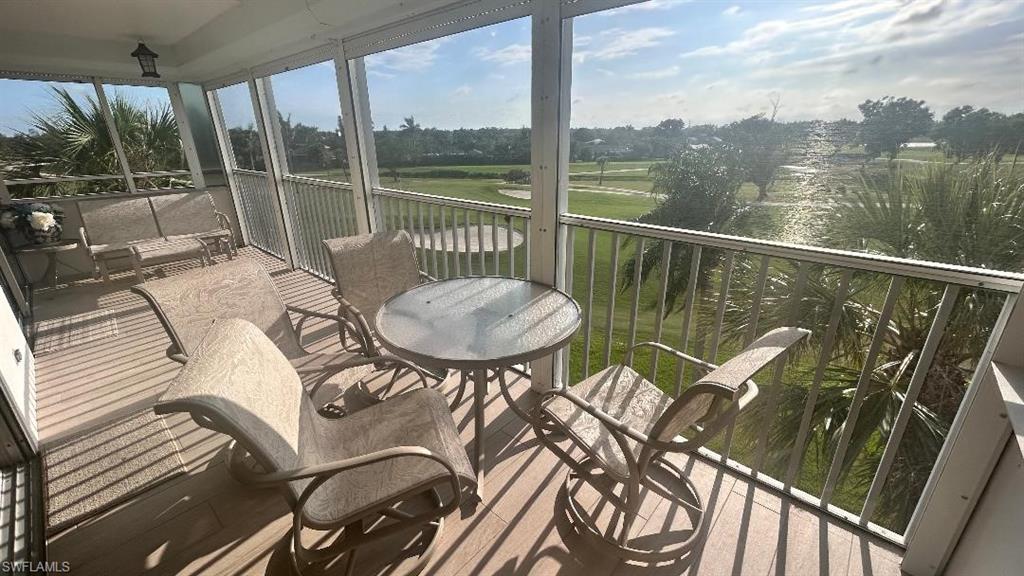 200 Pebble Beach Boulevard, Unit D402 Naples, FL 34113 - Photo 10 of 11 a balcony with table and chairs