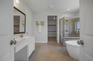 a bathroom with a bathtub shower sink and mirror