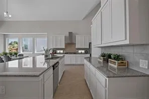 a kitchen with granite countertop kitchen island a counter top space a stainless steel appliances and cabinets