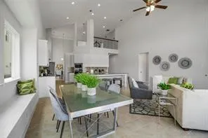 a dining room with furniture and a potted plant