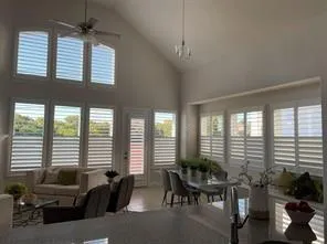 a living room with furniture and floor to ceiling windows