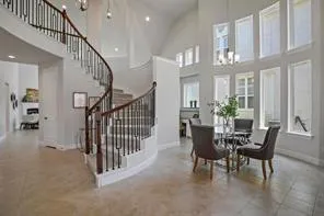 a view of a dining room with furniture and a chandelier