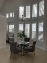 a view of a dining room with furniture and windows