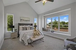 a bedroom with a bed and large window