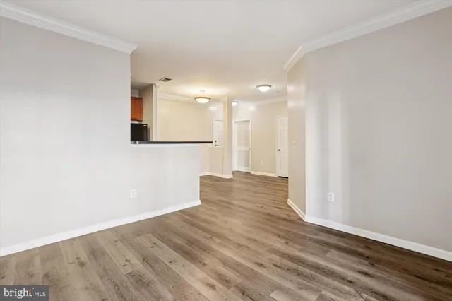 a view of a kitchen with wooden floor and a refrigerator
