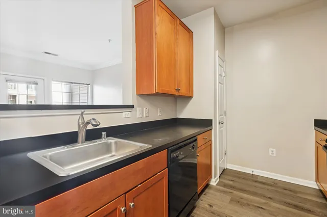 a kitchen with stainless steel appliances wooden cabinets and a stove top oven