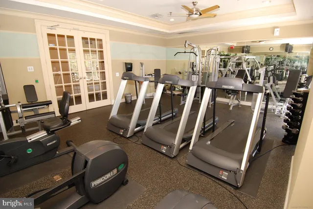 a room with pool table and windows