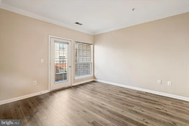 a view of a room with wooden floor and a sink