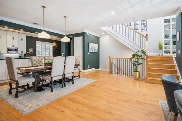 a dining room with furniture and wooden floor
