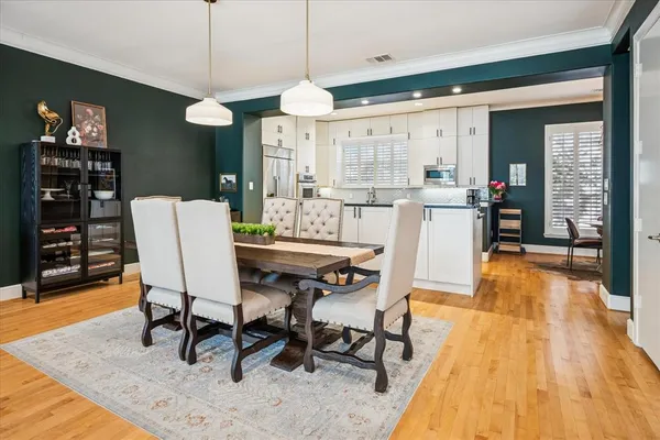 a large kitchen with stainless steel appliances a refrigerator and a sink