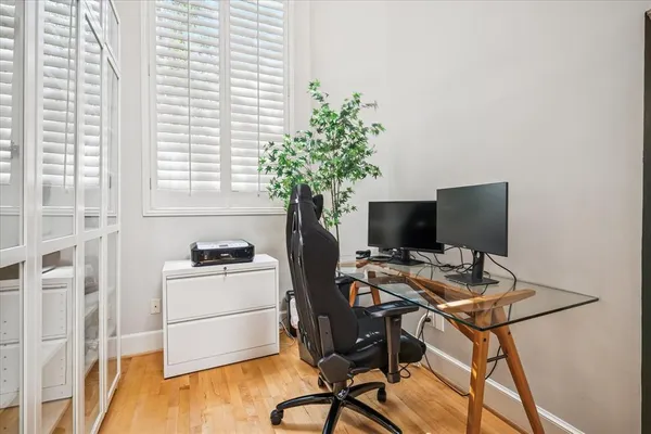 a large bed sitting in a bedroom next to a window