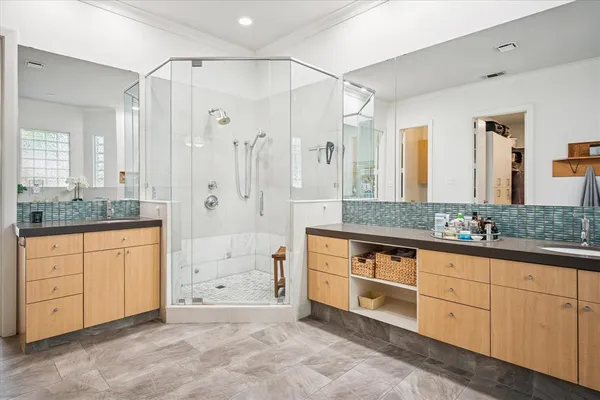 a spacious bathroom with double sink and a mirror