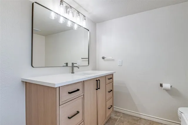 a bathroom with a sink a vanity and a mirror