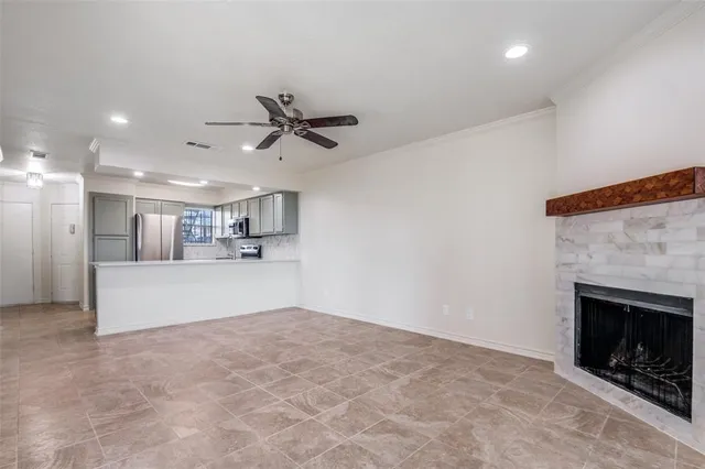 a view of a kitchen with a sink and a fireplace