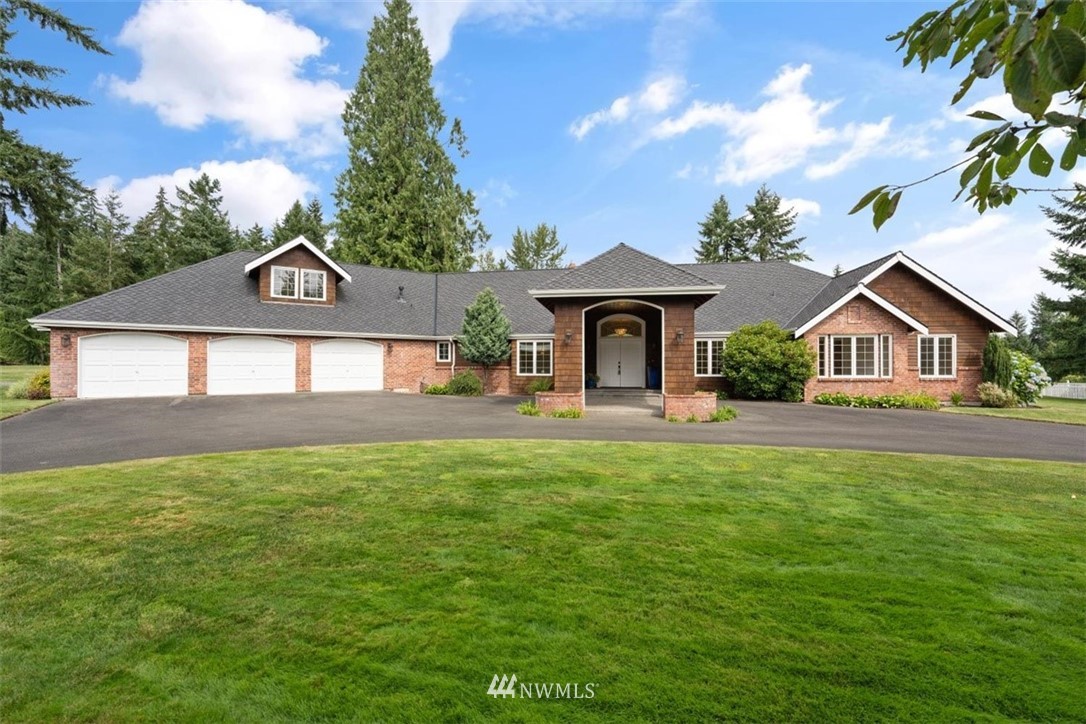 4801 166th Place Southeast Bothell, WA 98012 - Photo 1 of 40 a front view of a house with yard