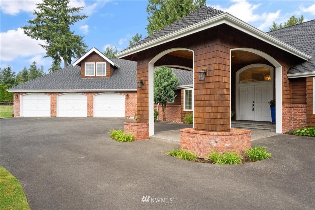 4801 166th Place Southeast Bothell, WA 98012 - Photo 2 of 40 a front view of a house with a yard and garage