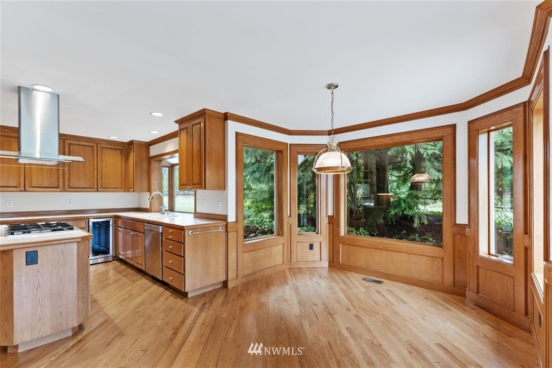 4801 166th Place Southeast Bothell, WA 98012 - Photo 14 of 40 a kitchen with stainless steel appliances granite countertop a stove and a wooden floors