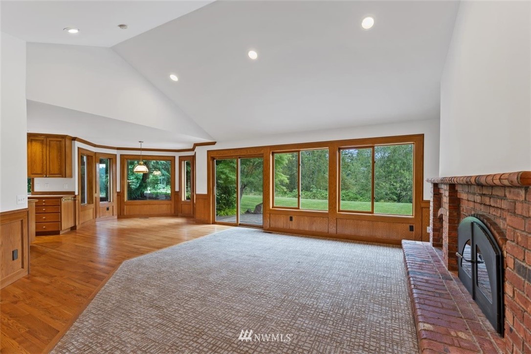 4801 166th Place Southeast Bothell, WA 98012 - Photo 18 of 40 a living room with fireplace furniture and a large window