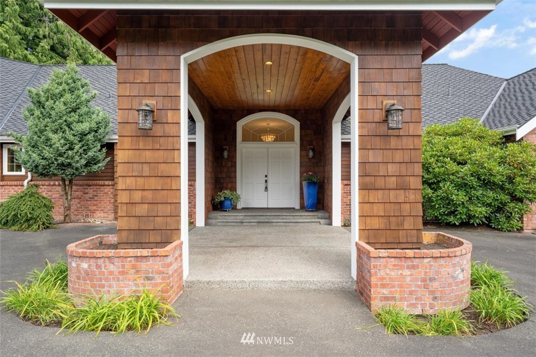 4801 166th Place Southeast Bothell, WA 98012 - Photo 3 of 40 a front view of a house with garden